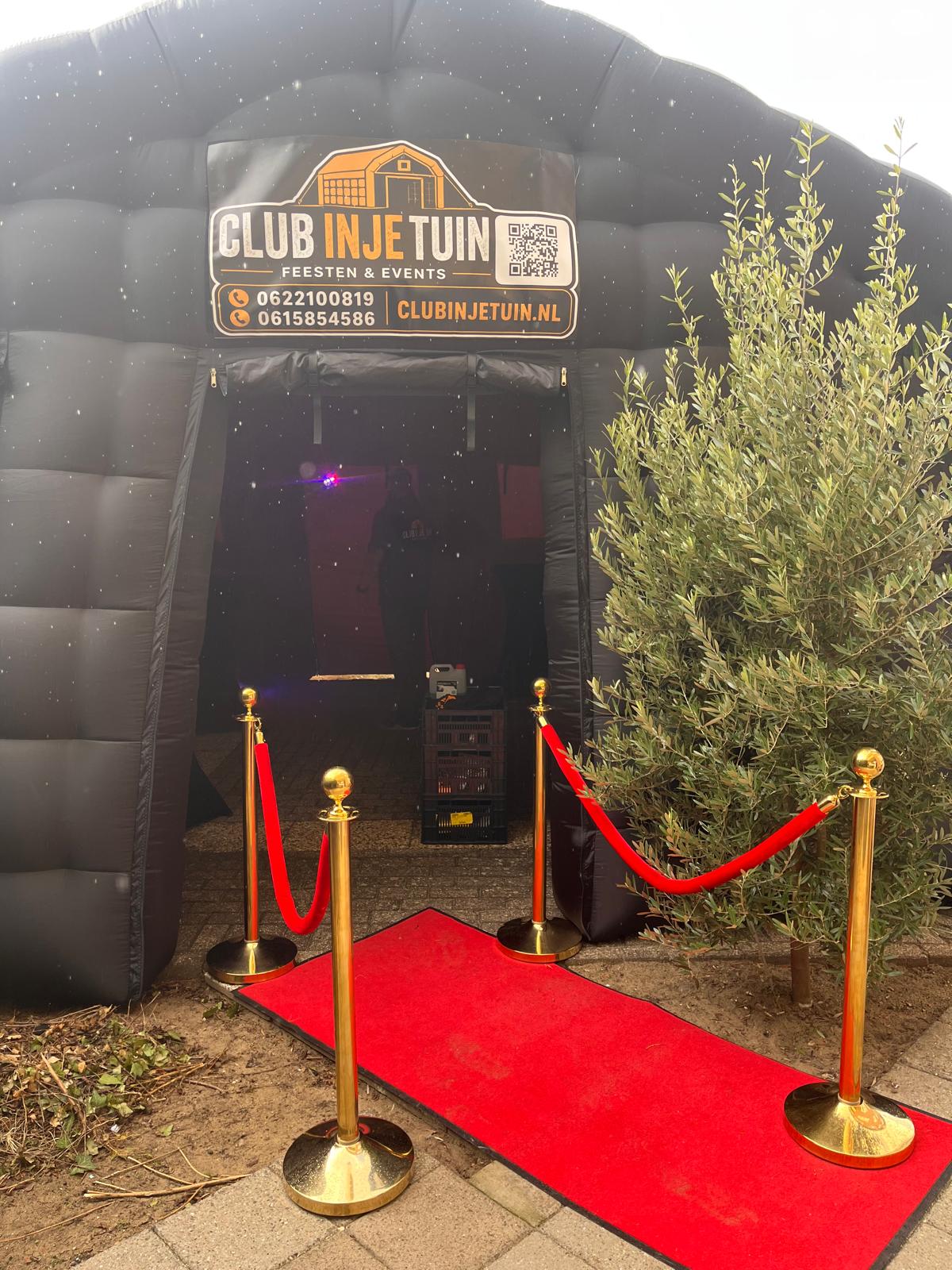 Opblaasbare discotent van Club in je Tuin opgezet in IJmuiden met rode loper en gouden afzetpaaltjes